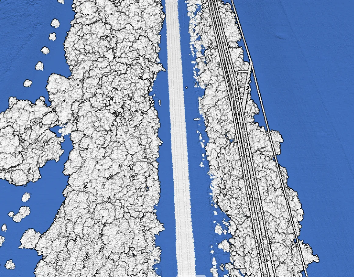 The same corridor as a flood-analysis surface: modeled water accumulation in blue against vegetation and the elevated track bed in white.